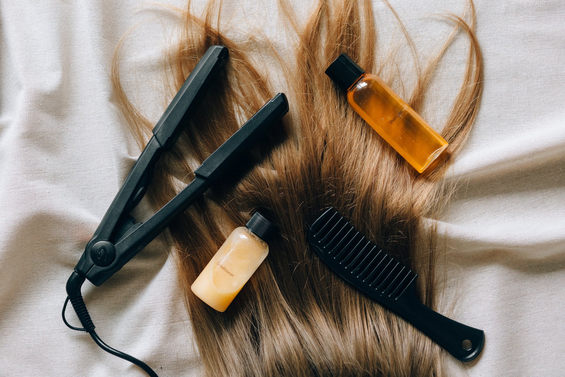 Black Hair Comb Beside White Plastic Bottle